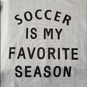 Long sleeve gray sweatshirt with heart on sleeve.